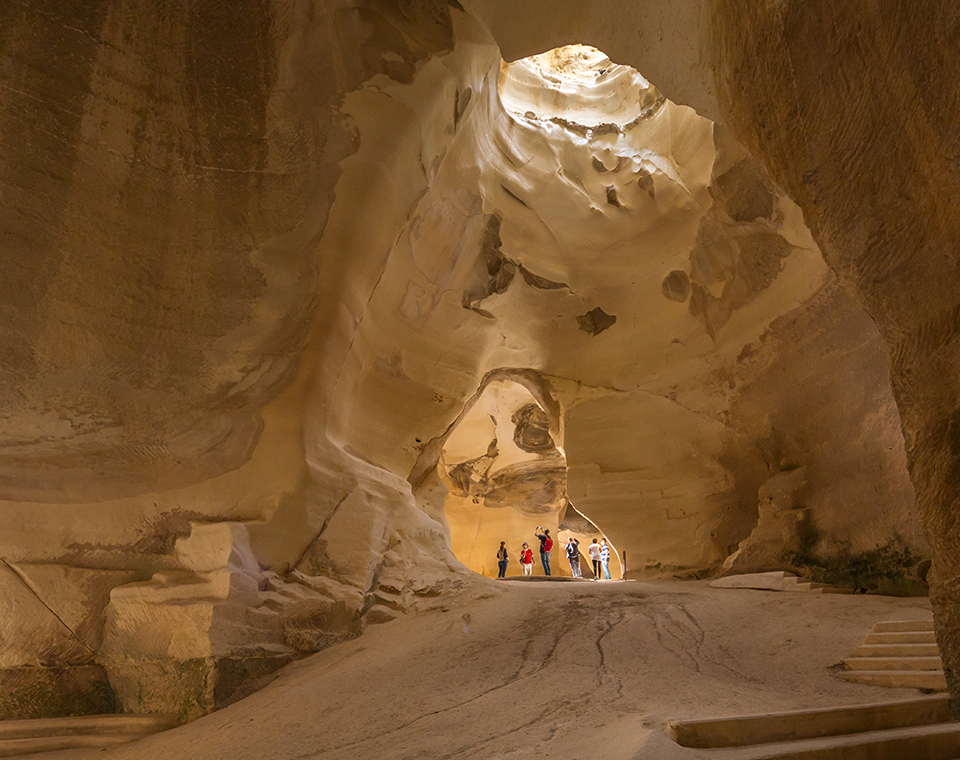 Sunlight streaming into the ancient limestone Bell Caves join an Israel Revealed tour.